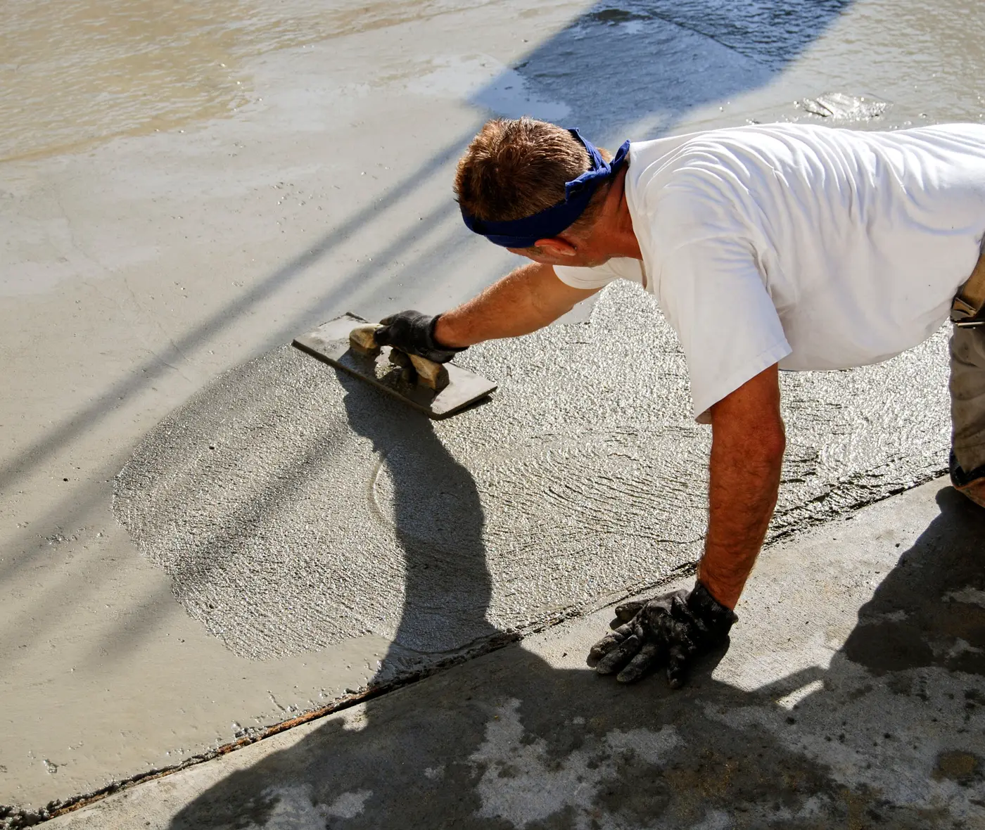 A Belco mason smoothing fresh concrete on a new slab