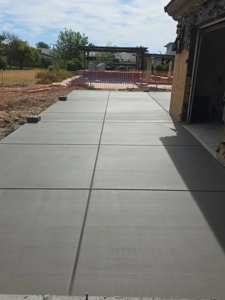 A finished Belco concrete driveway beside a home