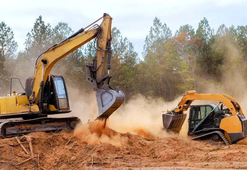 A dozer and an excavator moving earth on a jobsite